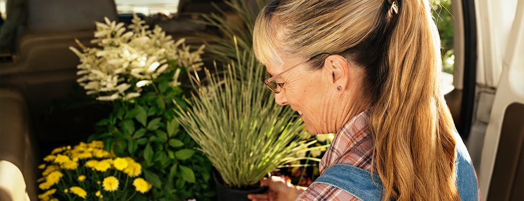 Image of middle aged woman looking at plants